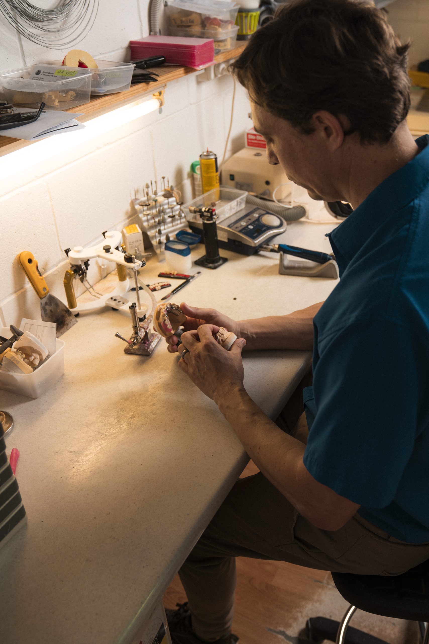 Dental technician working on a denture